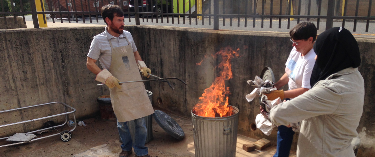 Bradley-B-Potter-Raku-Firing-Clinics Bradley working with students during raku firing